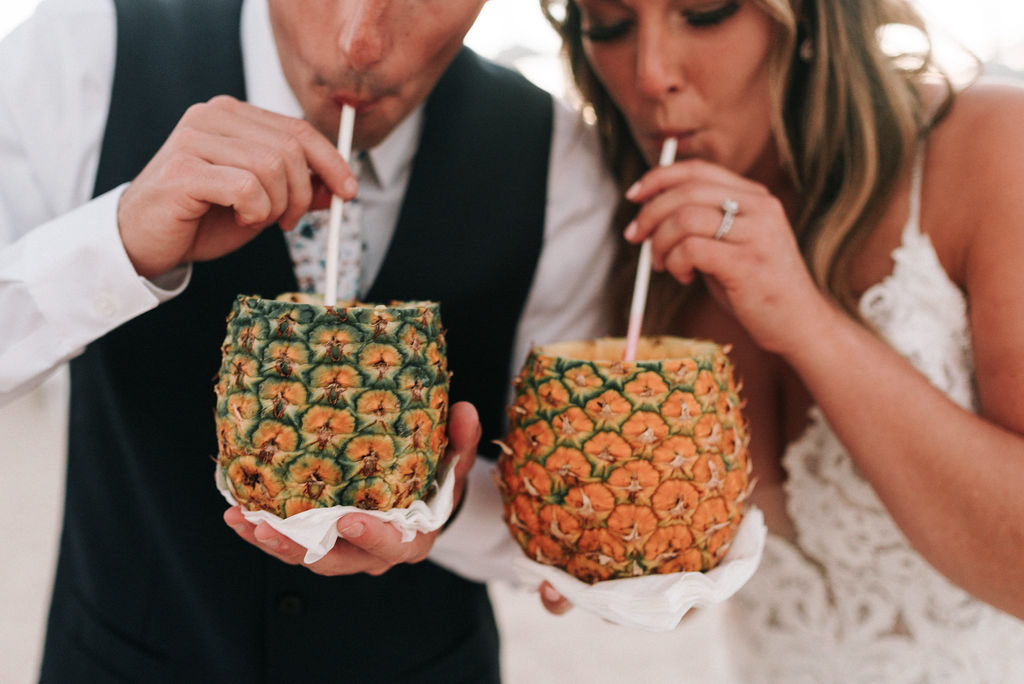 bride and groom drinking out of pineapples at destination Dominican beach wedding