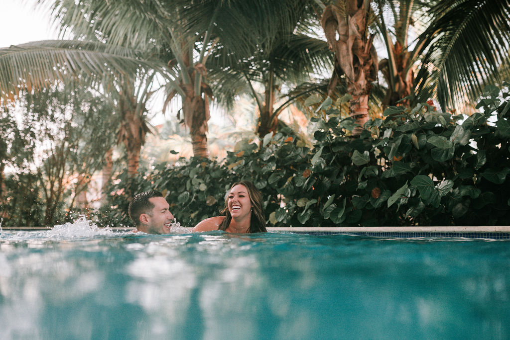 couple splashing in dip pool after destination elopement