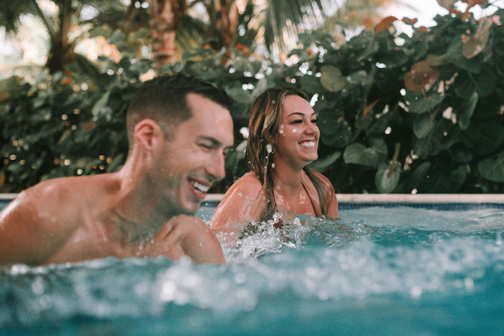 couple splashing in dip pool after destination elopement