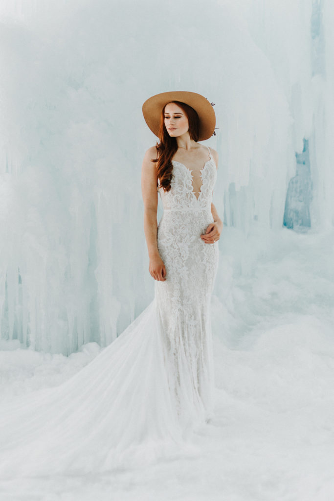 bride with hat at winter ice castle elopement in mn