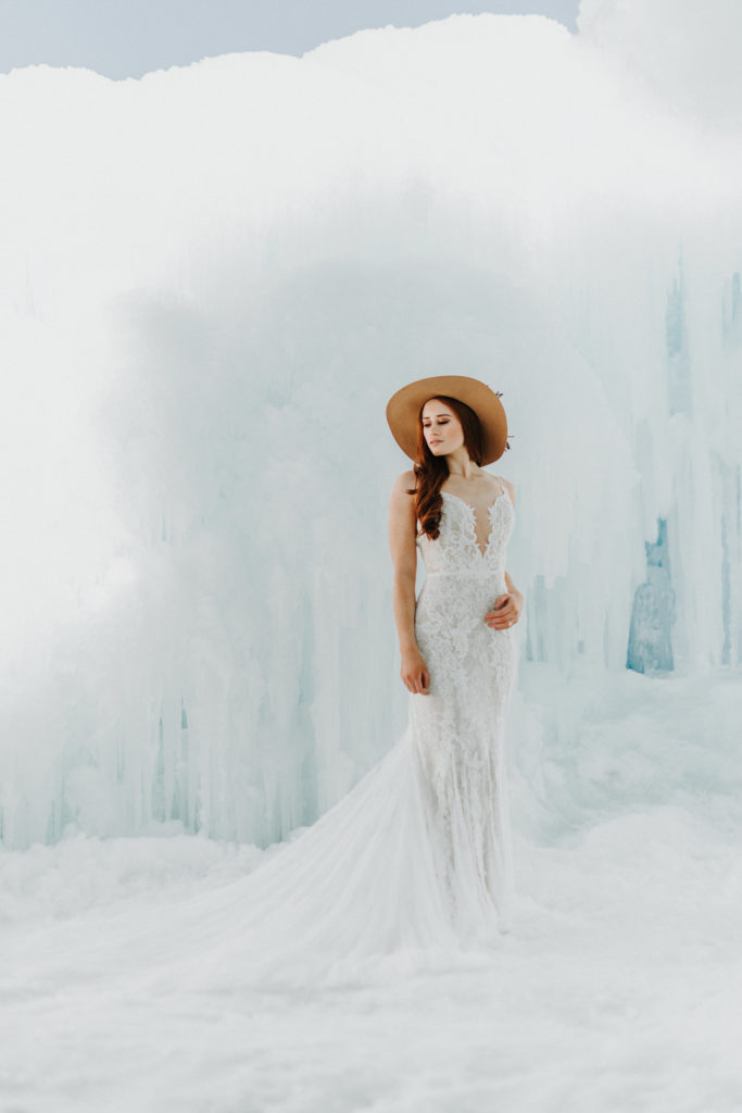 bride with hat at winter ice castle elopement in mn